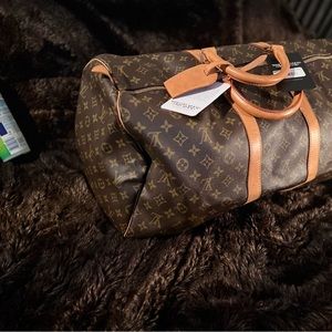 Louis Vuitton duffel with price tag and authenticity seal! Never been used!